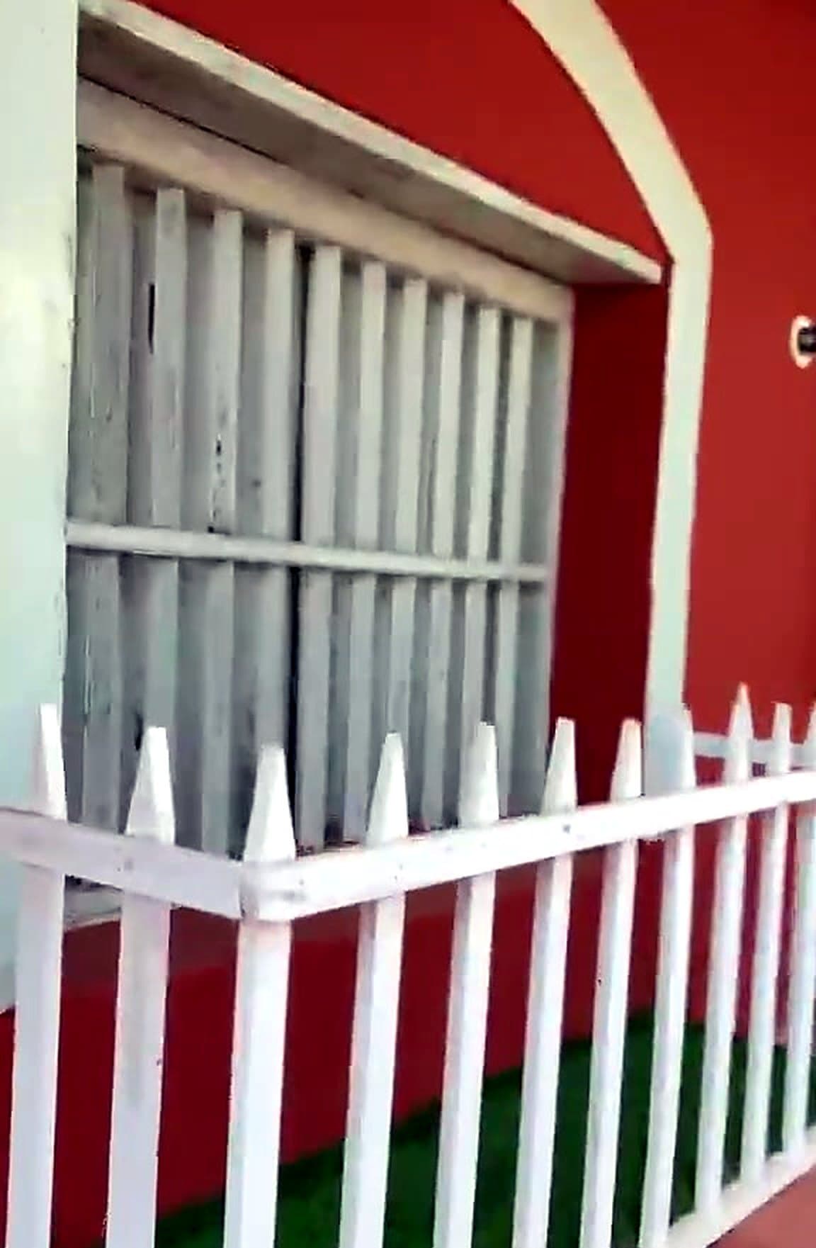 White fence and red walls of the homestay