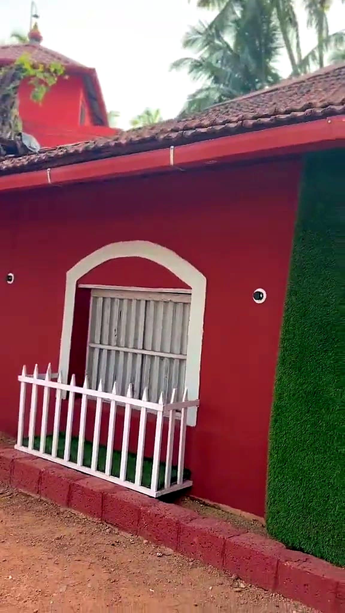 Arched window with white picket fence on the heritage house